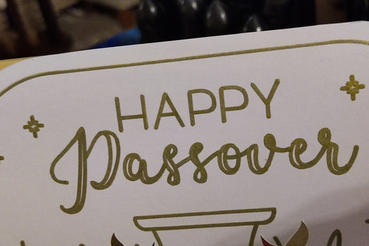 Zoomed-in view of “Happy Passover” lettering in metallic gold foil. Shows fine detail and high-quality printing on smooth white card.