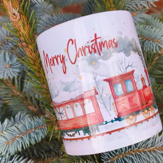 Holiday mug with red train and winter forest artwork displayed on tree