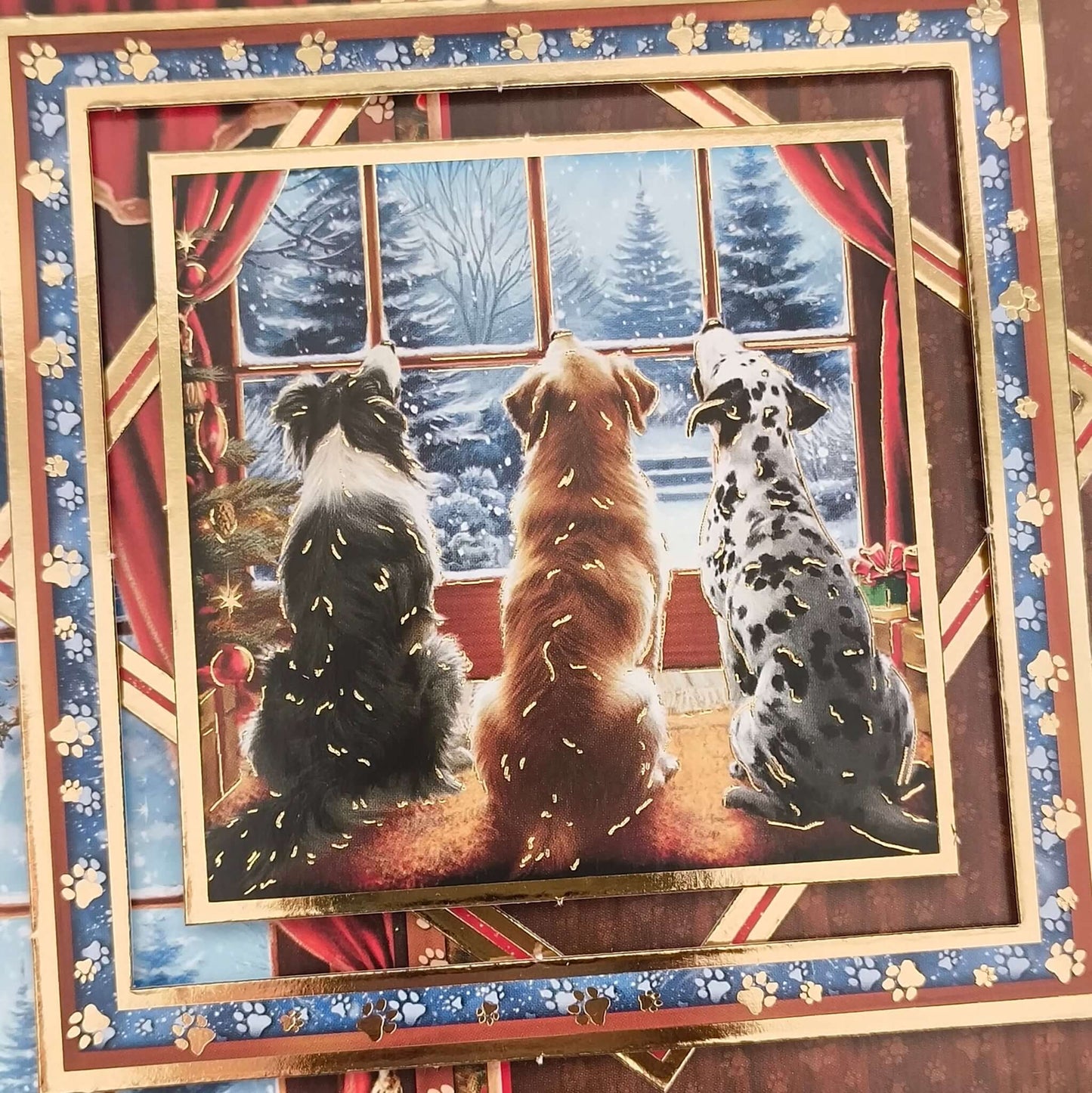 3D topper detail showing three dogs by the firelight looking out at a snowy Christmas Eve scene.