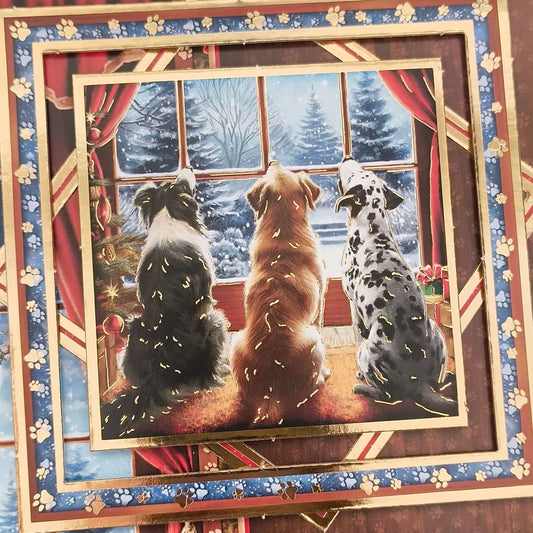 3D topper detail showing three dogs by the firelight looking out at a snowy Christmas Eve scene.
