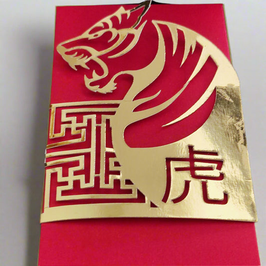 Gold foil tiger cut-out on red envelope for Lunar New Year with traditional Chinese character design