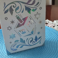 Luxury handmade Hanukkah card with dreidel design and Star of David cut-outs