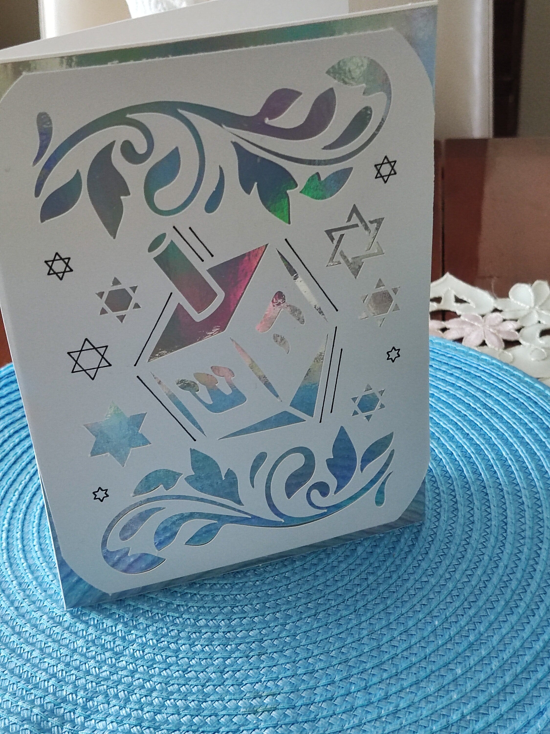 Luxury handmade Hanukkah card with dreidel design and Star of David cut-outs