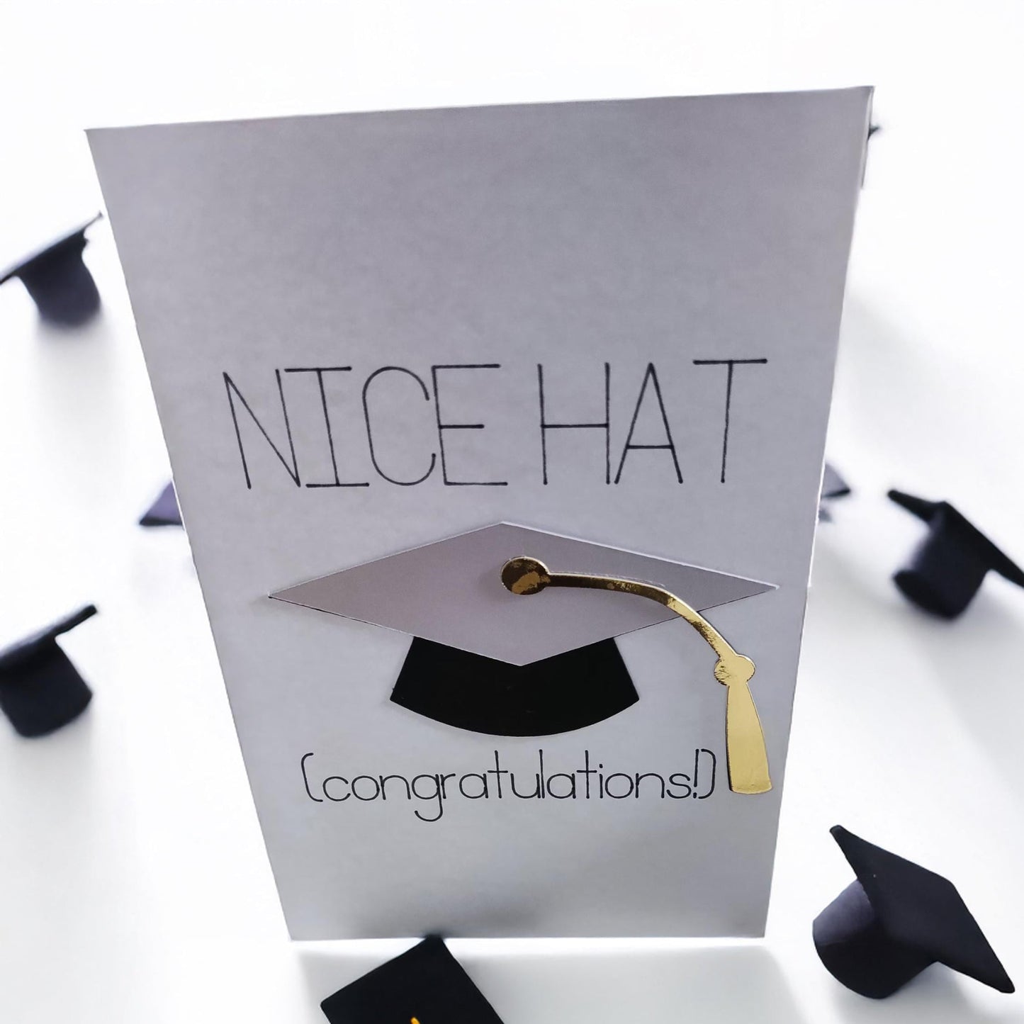 Funny handmade graduation card with 3D mortarboard and gold tassel saying "Nice Hat (congratulations!)"