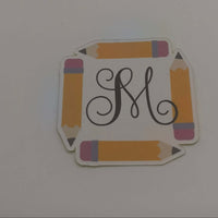 Personalised School Name Stickers featuring a decorative monogram framed by colorful pencil designs