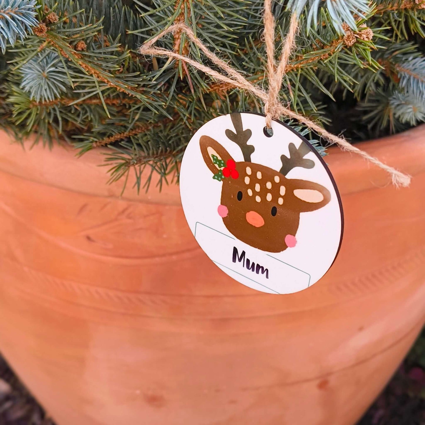 Personalised reindeer Christmas decoration with jute string hanging on tree, featuring ‘Mum’ text