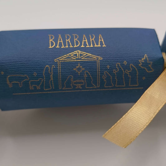 Personalised navy cracker detail with name ‘Barbara’ in gold foiling above a Nativity silhouette scene.