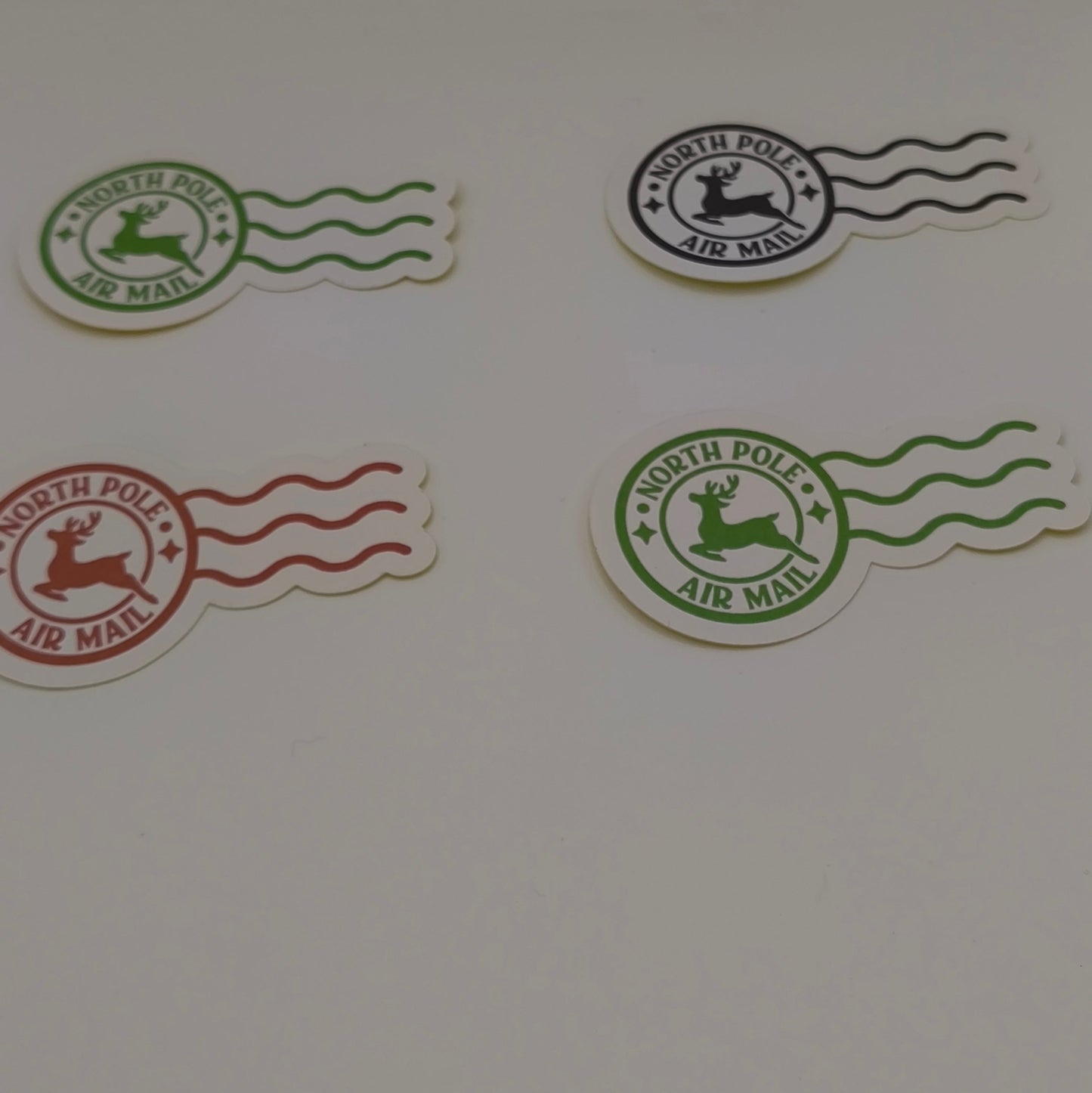 Set of North Pole Air Mail Christmas stickers in red, green, and black, shown on white background
