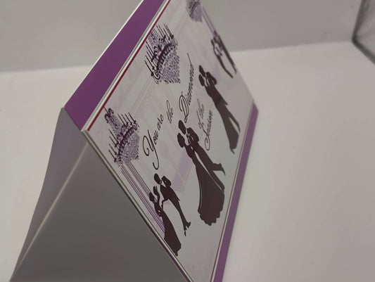 Vintage romantic greeting card featuring ballroom dancers in elegant attire and chandeliers.