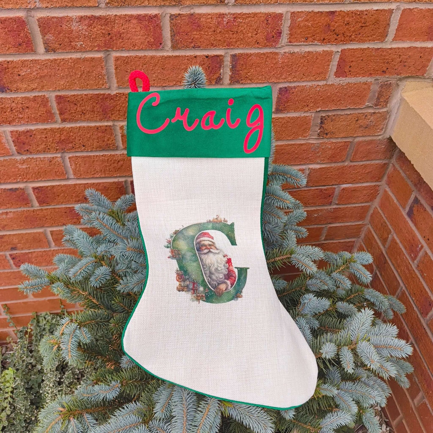 Personalised Vintage Santa Christmas Stocking with name Craig and initial C on a green cuff.