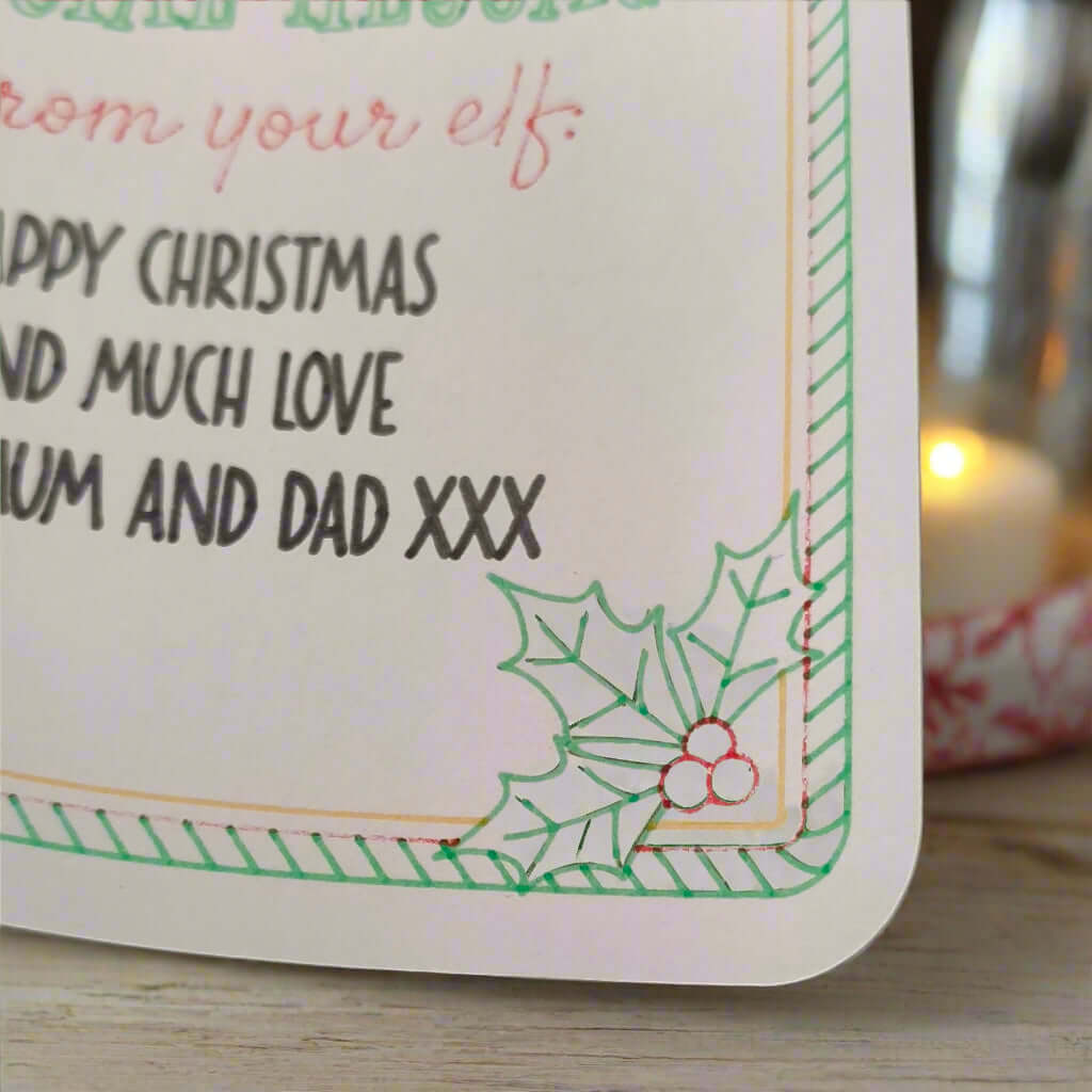 Close-up of Elf Special Message Sticker showing holly sprig detail and green striped border, personalised Christmas gift label design