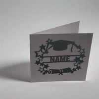 Personalised graduation card with cap, scroll, and star design, photographed from a left-side angle on a white background – handmade celebratory card.