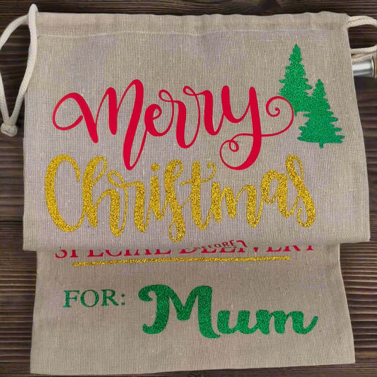 Personalised Merry Christmas gift sack for Mum – gold glitter text with red and green vinyl on rustic hessian fabric, festive tree design, perfect for holiday gifting.