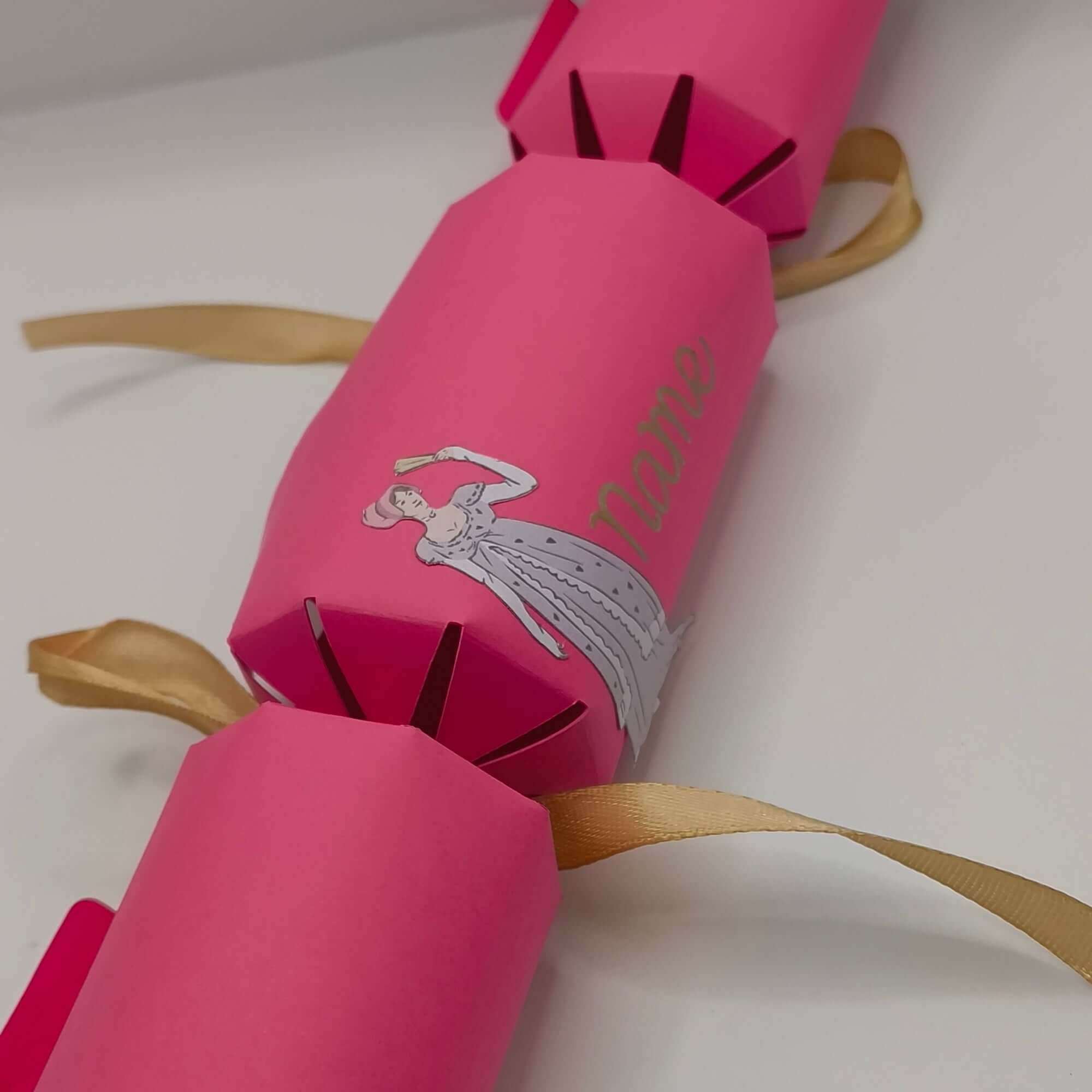 Elegant pink handmade cracker with vintage-inspired design and personalised name text in gold foil