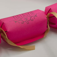Personalised Birthday Crackers in vibrant pink with golden ribbon, perfect for celebrations.