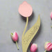 Pink tulip place card with personalised name “Elizabeth” written on the leaf, crafted from textured cardstock, displayed with small tulip buds.