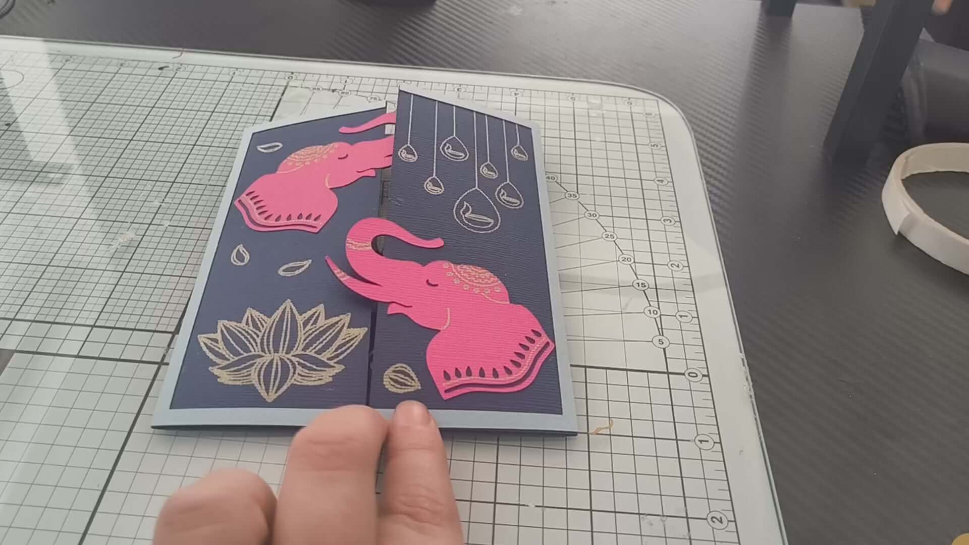 Handmade Diwali card featuring pink elephants and gold lotus design on a navy background.