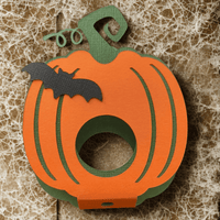 Cute Halloween pumpkin lollipop holder with bat design, perfect for kids' treats and parties.