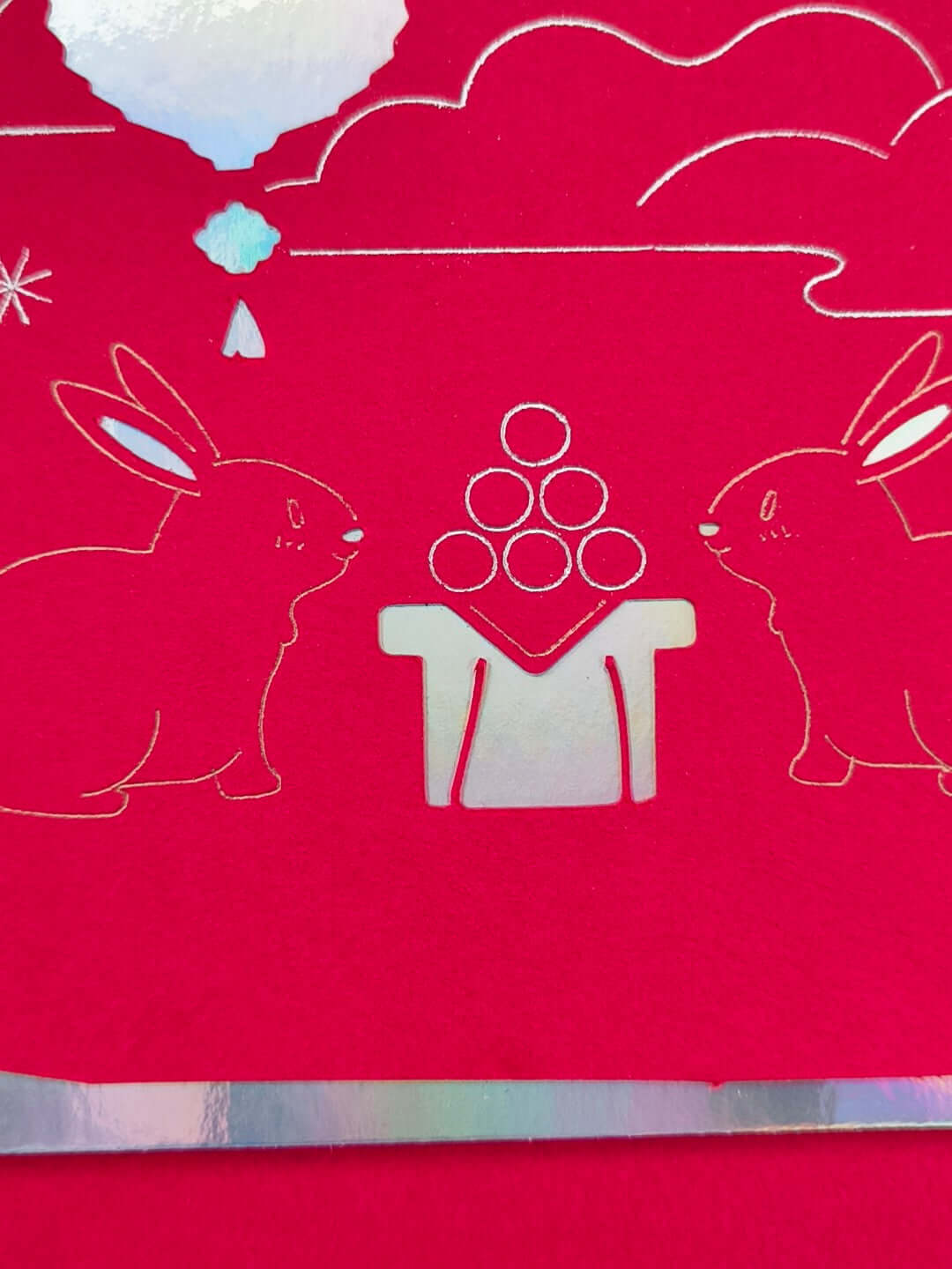 Handmade red foil card featuring two moon rabbits and a glowing lantern for Mid-Autumn Festival celebration.