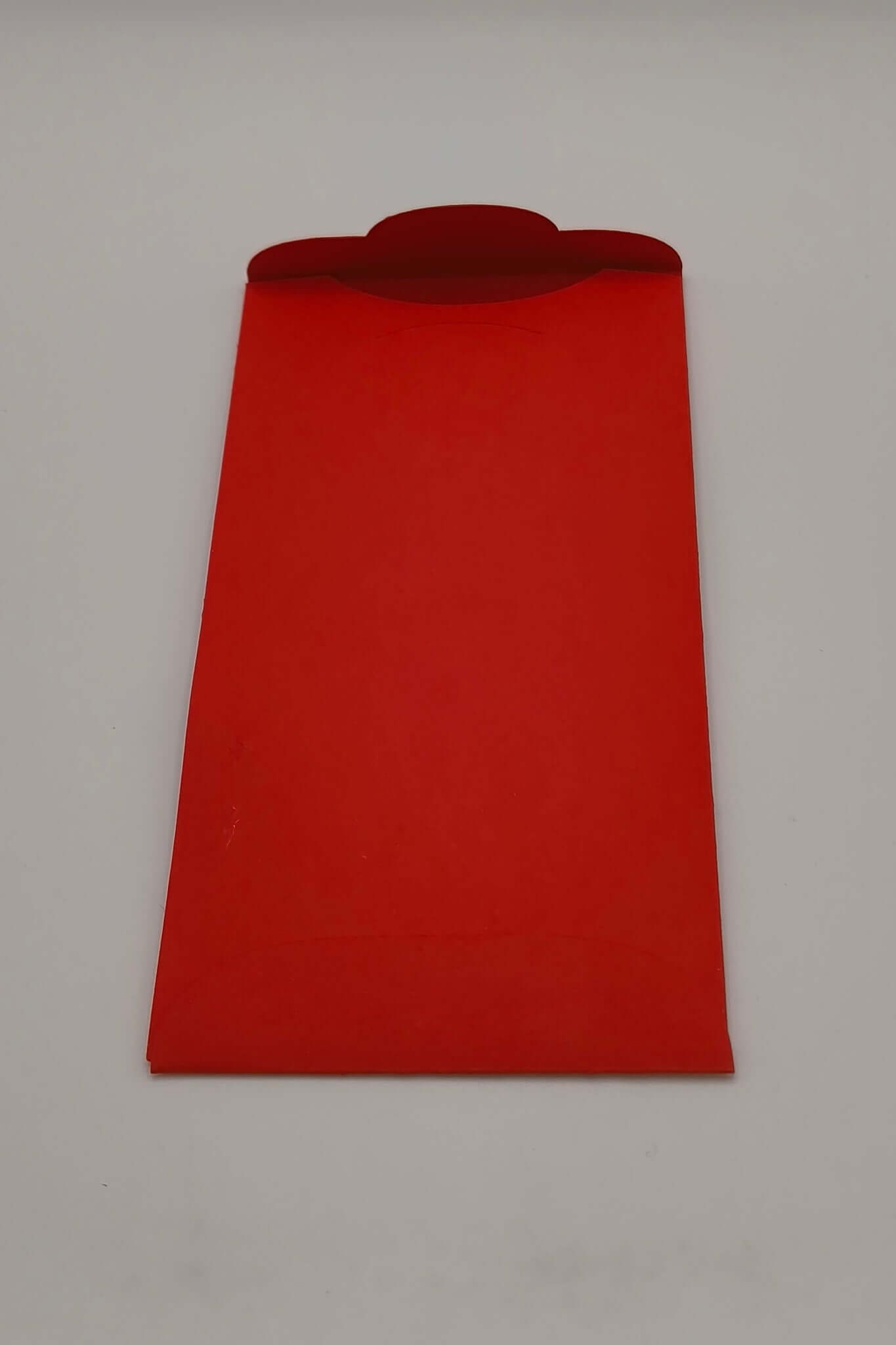 Back of red Chinese New Year envelope with flap open for inserting notes or gifts.