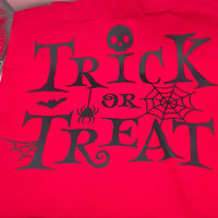 Handmade red cotton tote bag with black Trick or Treat lettering and Halloween spider web design, reusable eco-friendly sweet bag.