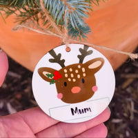 Close-up of reindeer Christmas bauble with ‘Mum’ personalisation hanging on fir branch