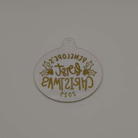 Reverse view of personalised gold and clear acrylic first Christmas bauble showing text from back.