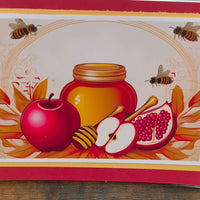 Colourful Rosh Hashanah card featuring apples, honey jar, pomegranate, and bees, celebrating the Jewish New Year.