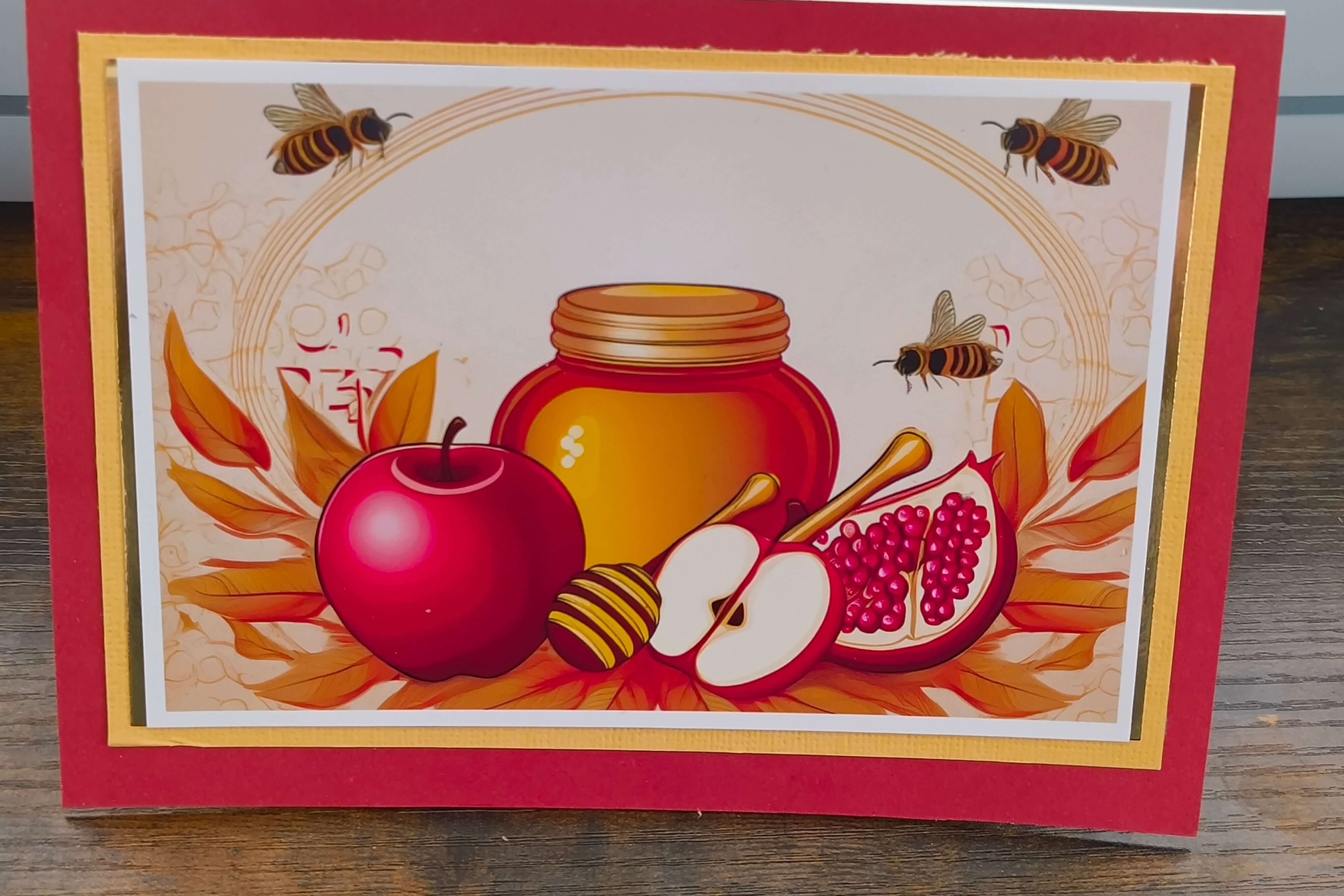 Colourful Rosh Hashanah card featuring apples, honey jar, pomegranate, and bees, celebrating the Jewish New Year.
