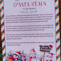 Letter from the desk of Santa Claus featuring penguins, snowmen, and reindeer artwork, personalised for a child named Emily Smith, printed on festive candy stripe bordered paper.
