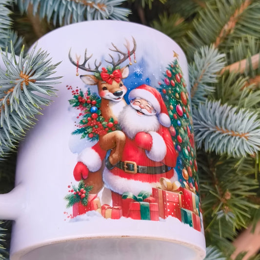 Close-up of Christmas mug showing Santa Claus with a reindeer and decorated Christmas tree, festive design with gifts