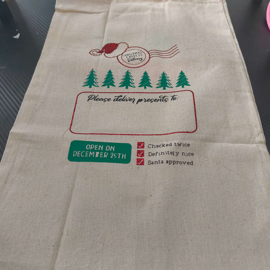 Personalised Santa sack featuring festive design with Santa hat and Christmas trees, perfect for kids' gifts.