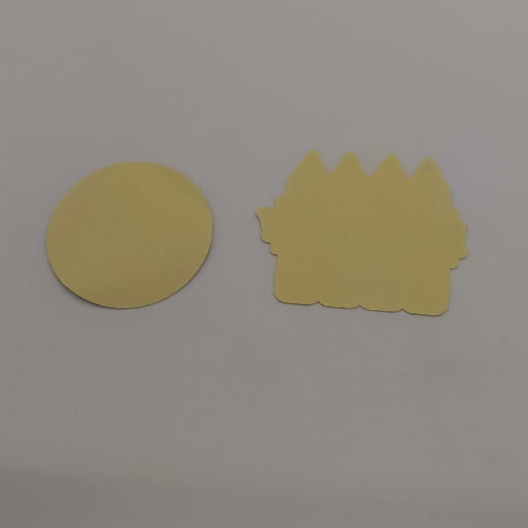 Personalised school name stickers in yellow round and castle shapes for organized school supplies.