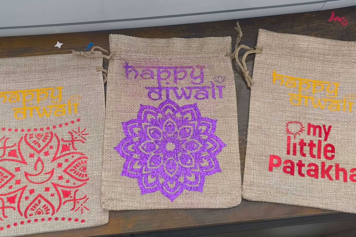 Personalised hessian bags for Diwali featuring intricate designs and festive messages. Perfect for gifts and party favours.