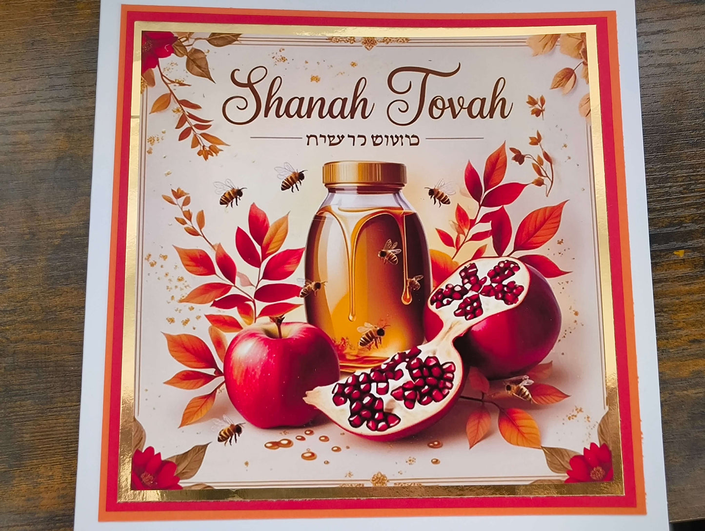 Shanah Tovah card featuring apples, honey, and pomegranate with autumn leaves, symbolising Rosh Hashanah blessings.