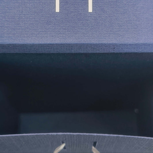 Top view inside navy Ganesh gift box showing slots for ribbon closure, handmade for Hindu celebrations and festive gifting.