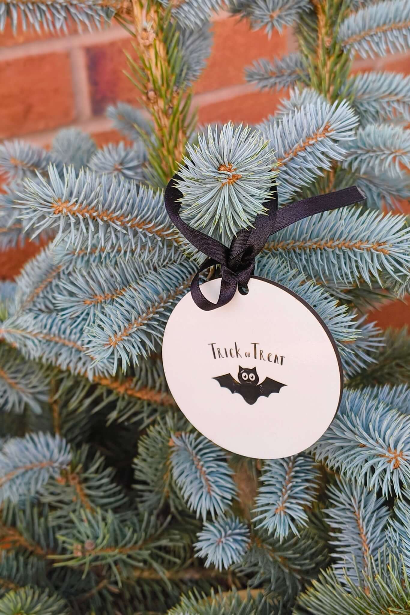 Trick or Treat Halloween bauble with bat ornament design, personalised with name and year.