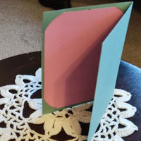 Handmade Easter greeting card featuring a pink and green cut-out design, showcasing a cheerful spring theme.