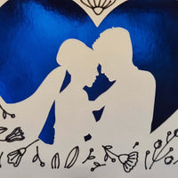 Handmade wedding congratulations card featuring a blue heart and floral design with a romantic silhouette of a couple.
