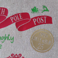 Design of a festive sack featuring 'North Pole Post' and 'Open December 25' in red and green colors.