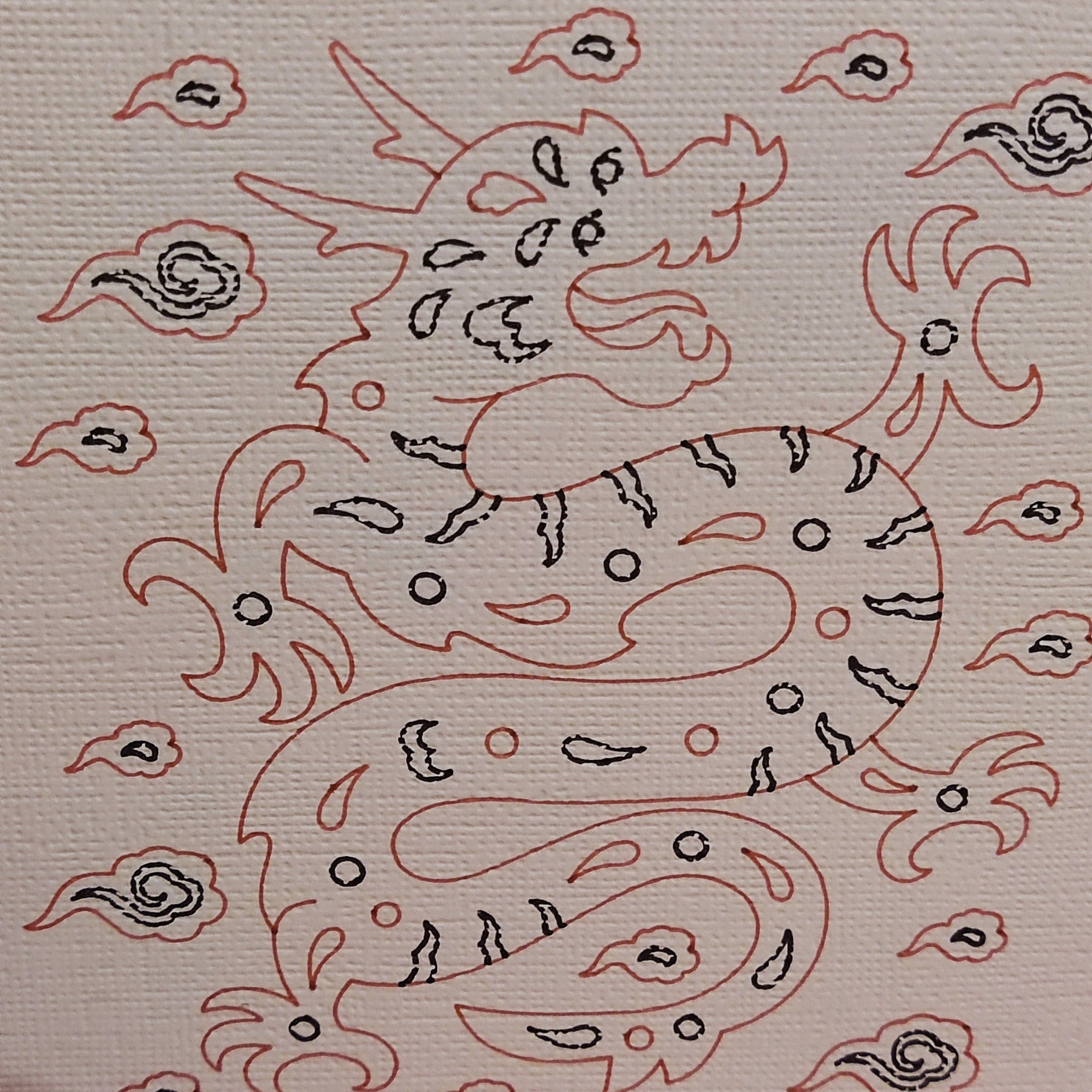 Illustration of a dragon surrounded by clouds, depicted in red and black on textured cardstock.