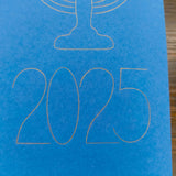 A close-up of the year '2025' finely outlined in gold on a bright blue card. The elegant, modern typography sits beneath the base of a menorah design, part of a minimalist Hanukkah-themed card.