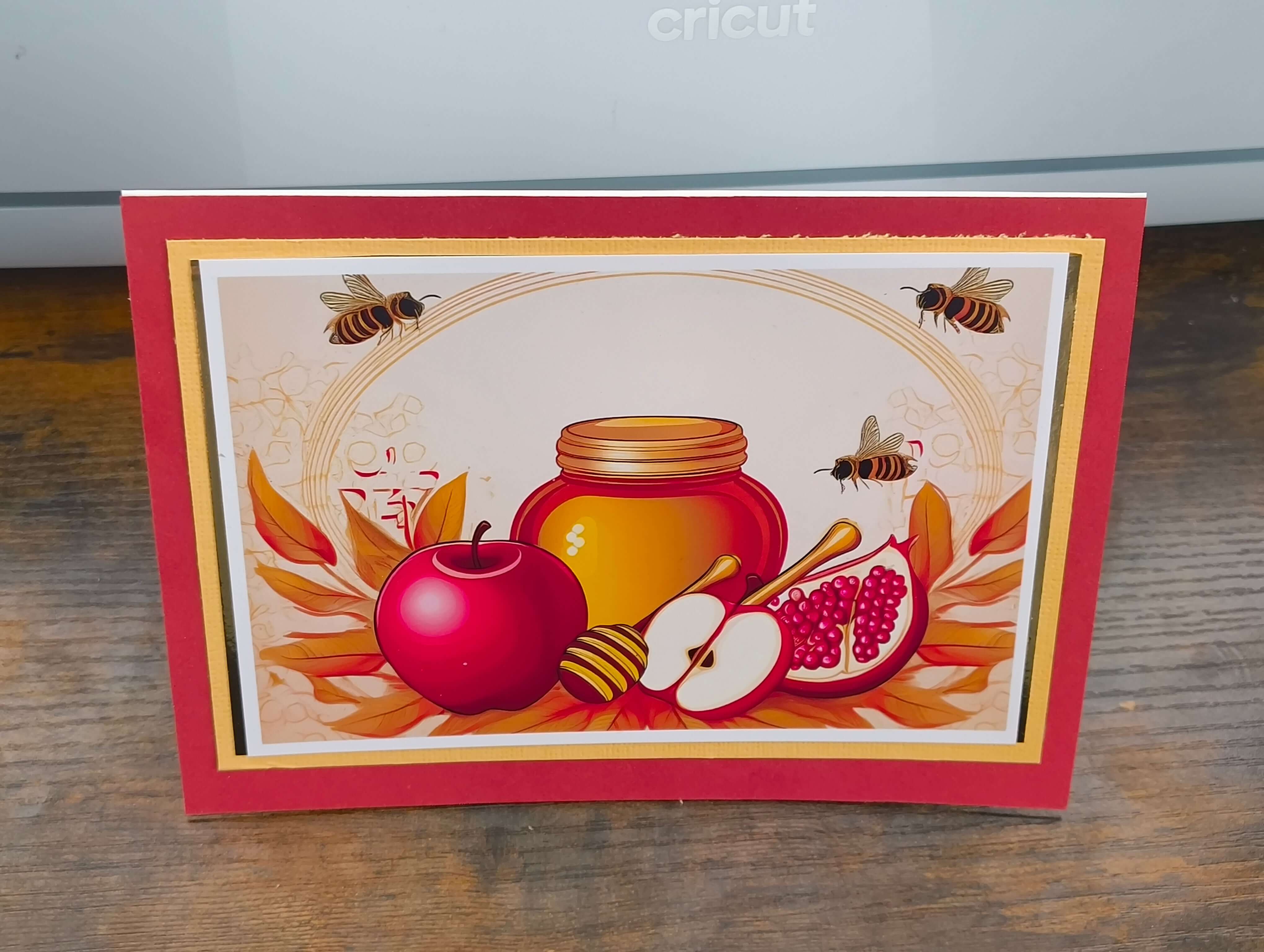 Vibrant Rosh Hashanah card with honey, apples, and pomegranates, celebrating the Jewish New Year.