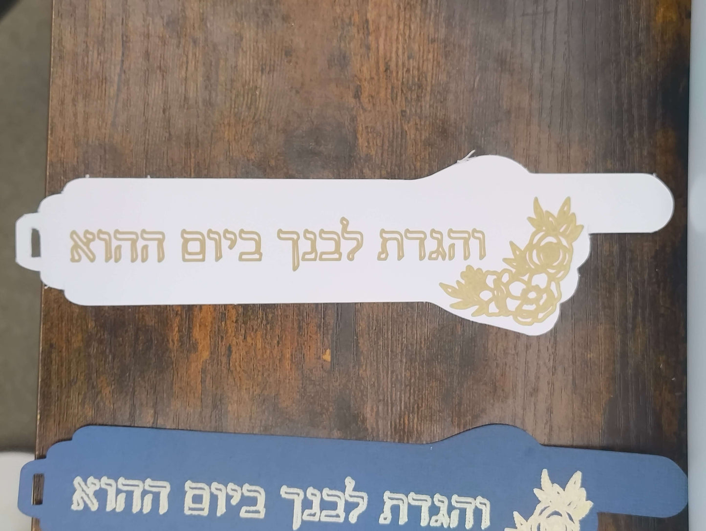 Handmade Passover bookmarks in white and blue with gold foil Hebrew verses.