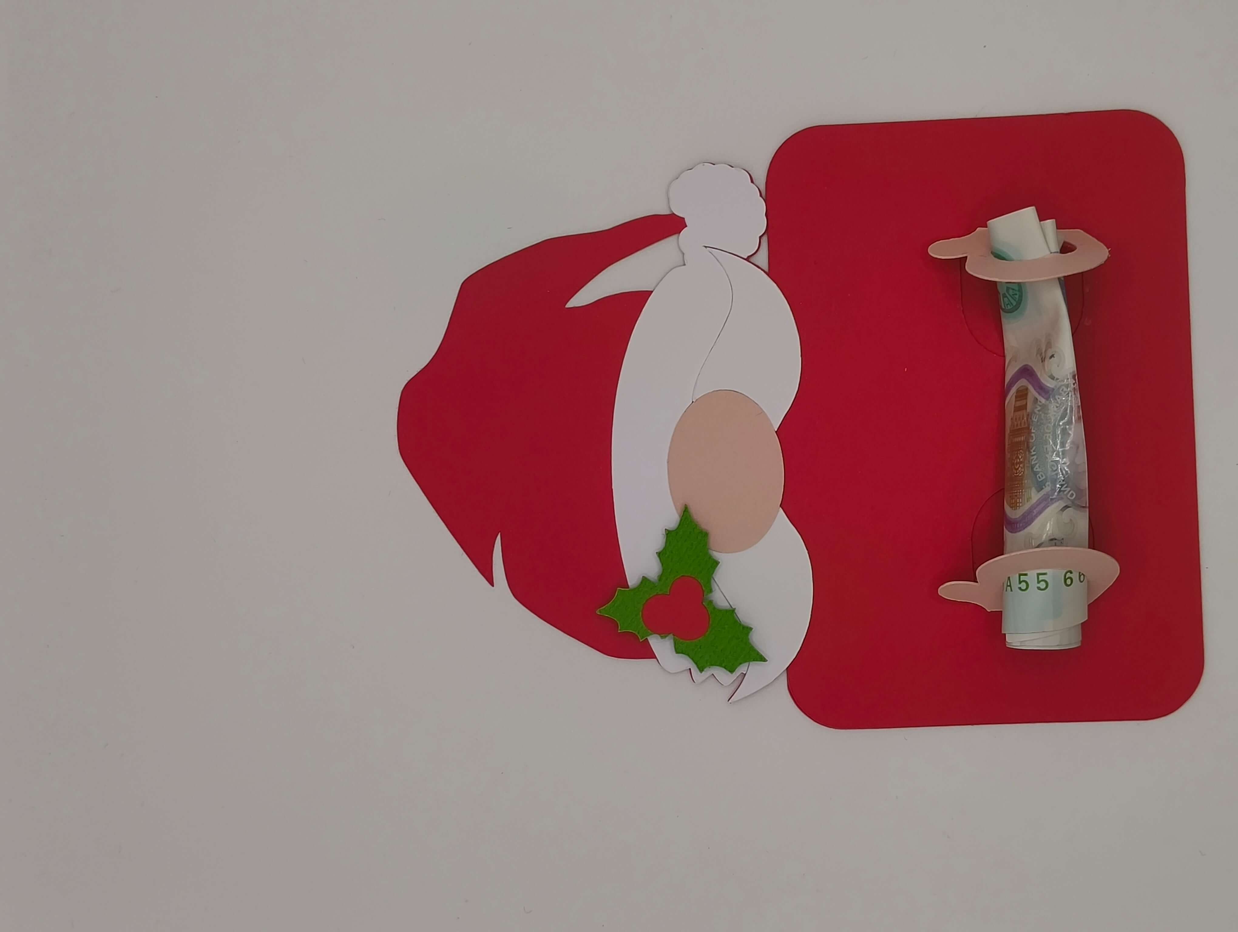 Personalised Santa money holder card with a banknote, featuring Santa hat and holly detail, perfect for Christmas gifting.