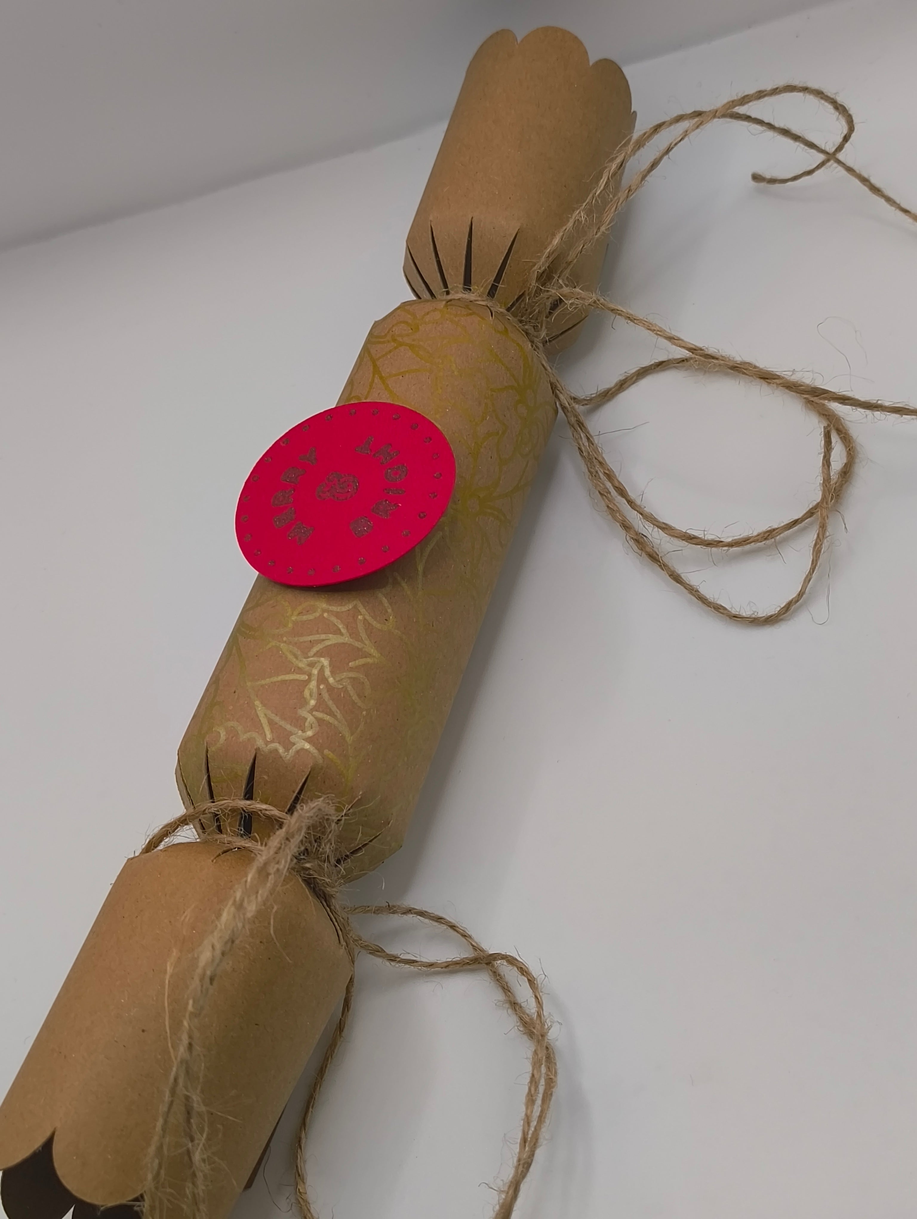 Eco-Friendly Christmas Crackers with gold holly design and jute twine for a rustic festive look.