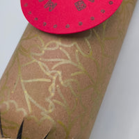 Eco-friendly Christmas crackers with gold holly design and rustic jute twine, perfect for festive celebrations.