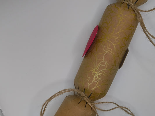 Eco-friendly Christmas crackers with gold holly design and natural jute twine for a rustic festive look.