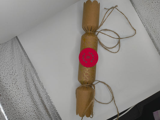 Eco-friendly Christmas crackers with gold accents and jute twine for a rustic festive touch.