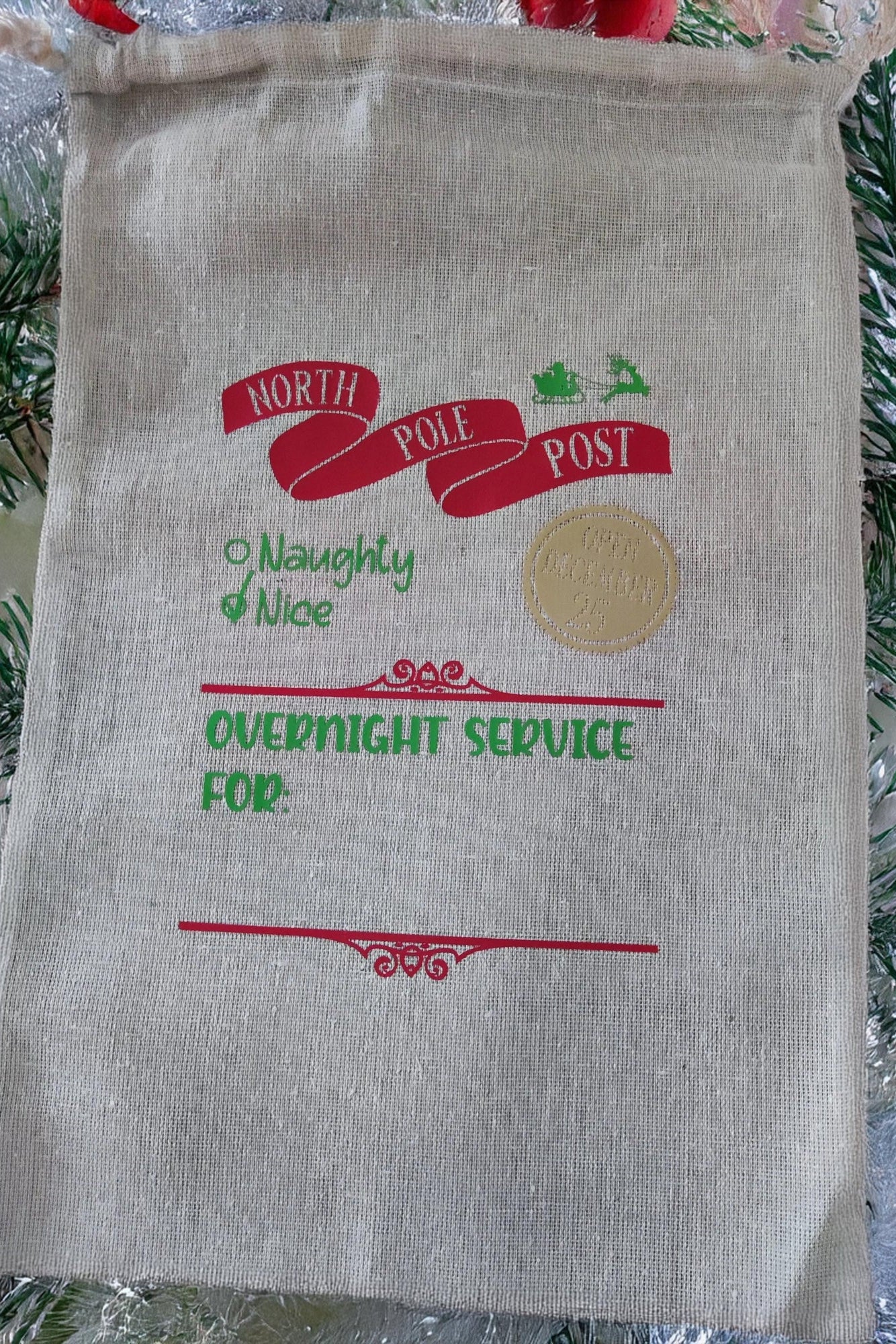 Personalised North Pole Delivery Sack featuring festive design, Naughty & Nice list, and overnight service details.